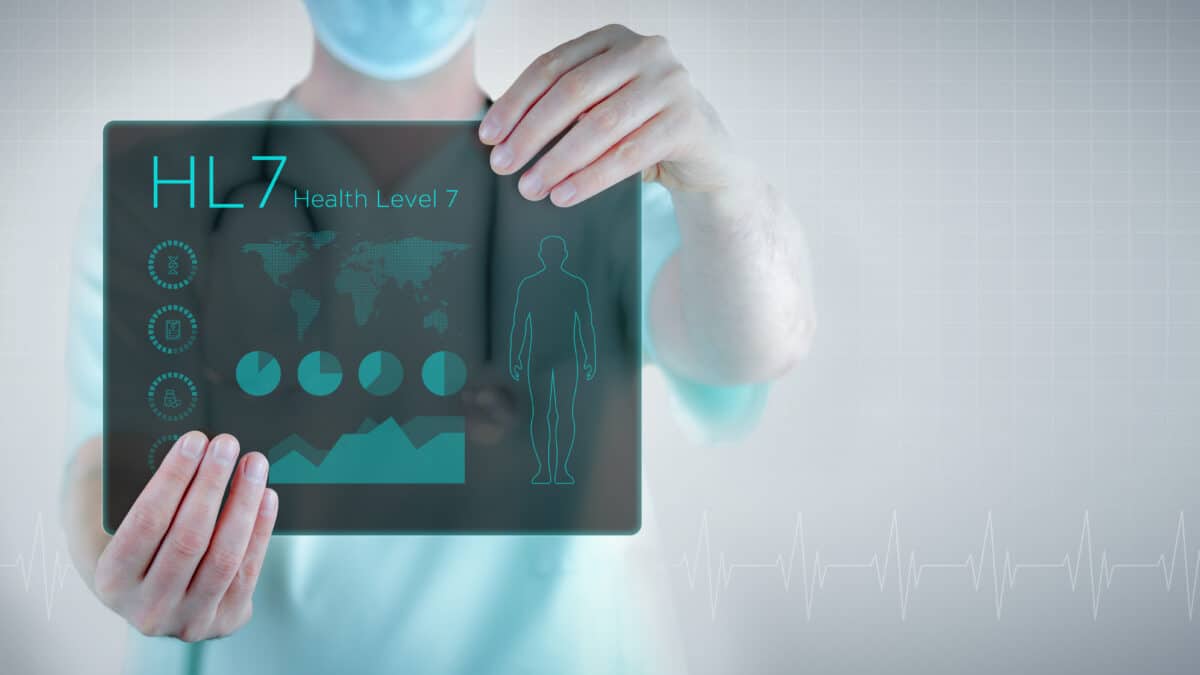 Doctor holds futuristic tablet showing 'HL7' to symbolize advanced clinical documentation technology