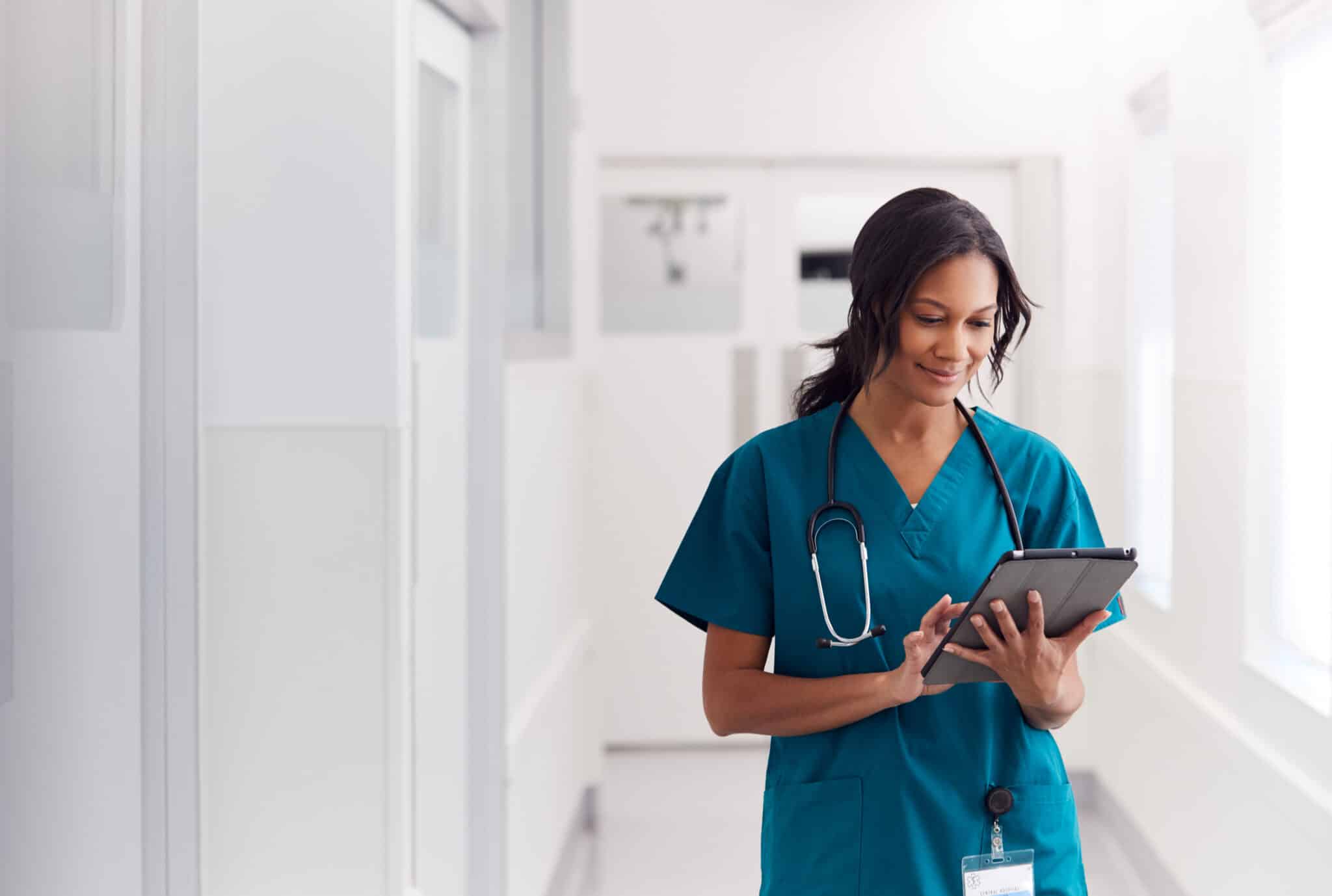Doctor uses table, accessing patient data for Clinical Documentation Improvement and transcription.