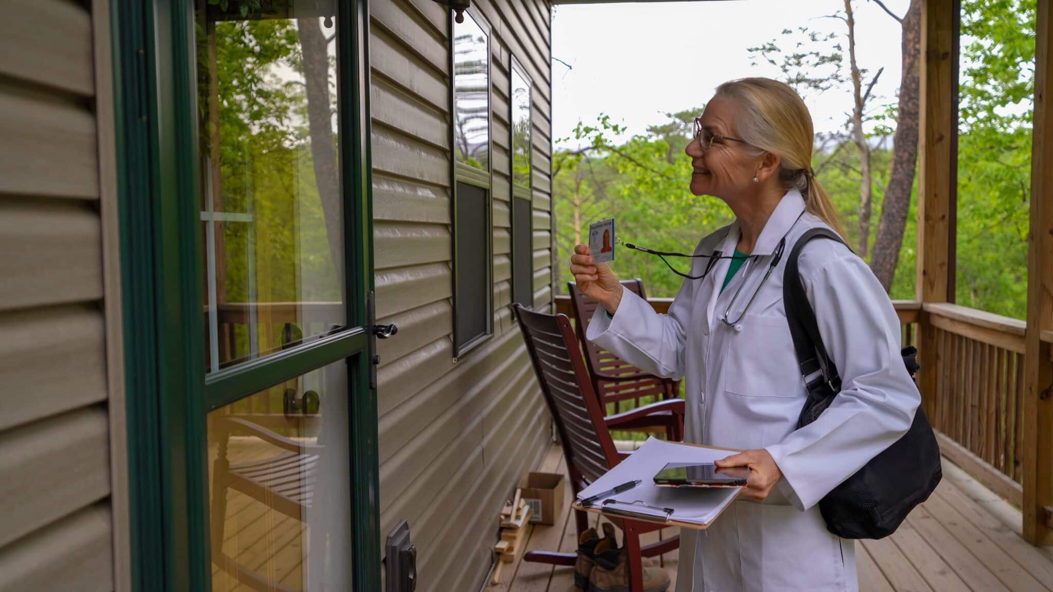 A traveling physician arrives for a home visit. She will dictate the patient notes in her iPhone.