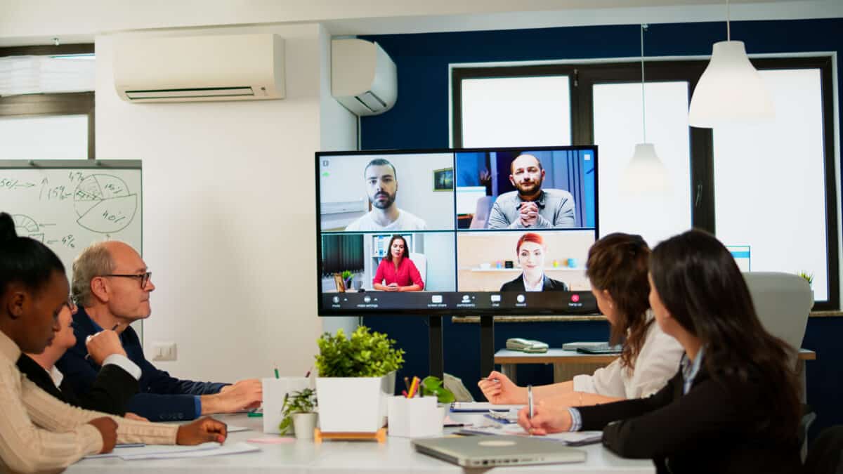 Diverse group participates in quarterly earnings call, depicting the need for finance transcription.