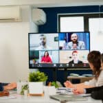 Diverse group participates in quarterly earnings call, depicting the need for finance transcription.