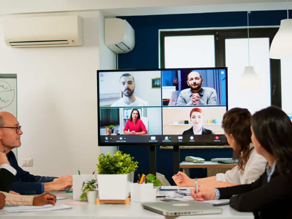 Diverse group participates in quarterly earnings call, depicting the need for finance transcription.