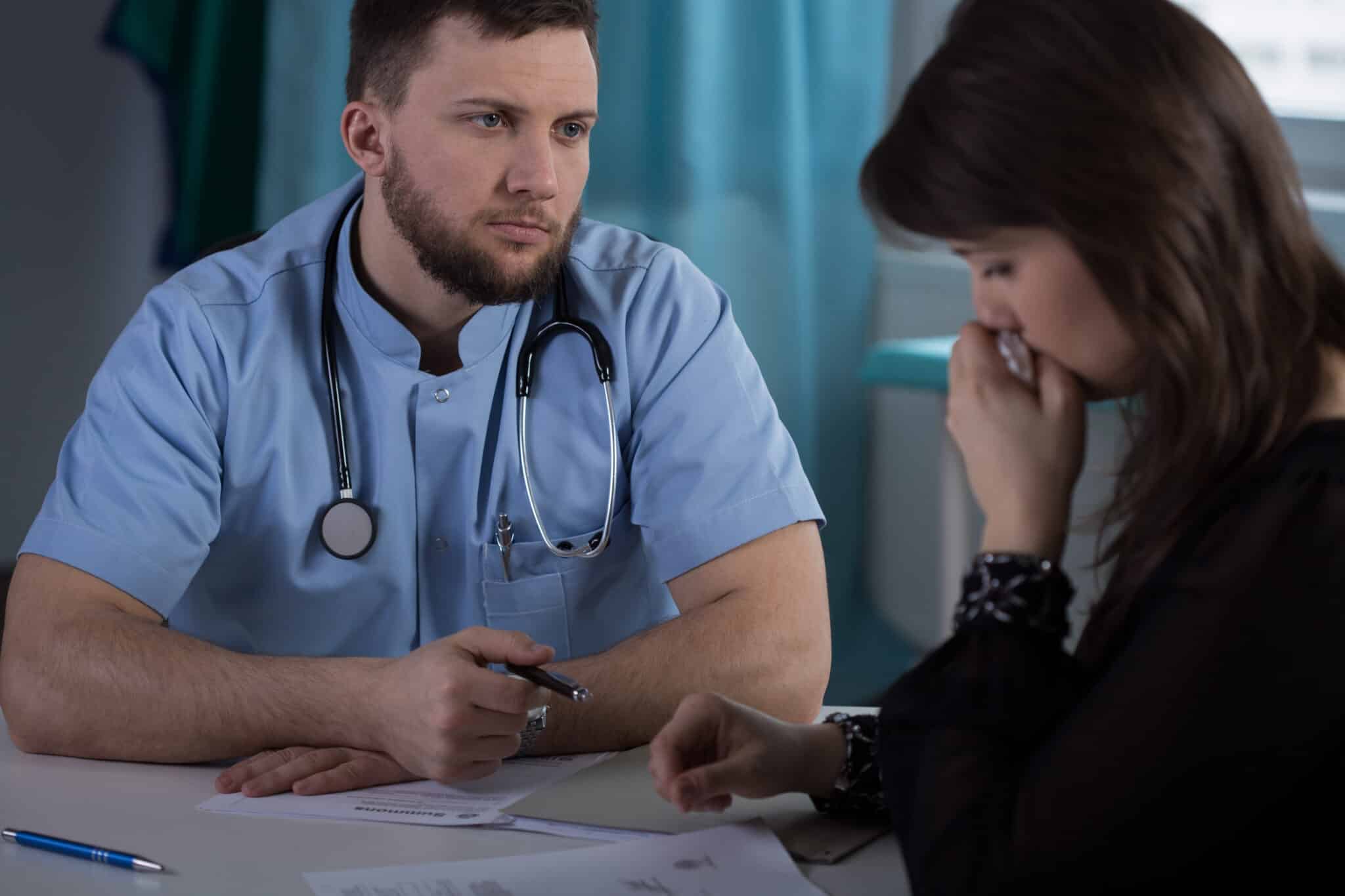 Doctor pondering inconsistencies in his EHR notes, highlighting the need for accurate records.