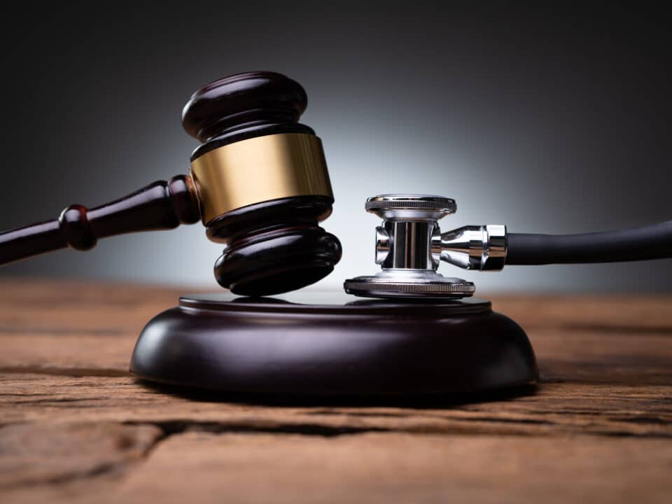 Gavel and stethoscope symbolize the role of medical transcription in legal defense and patient care.