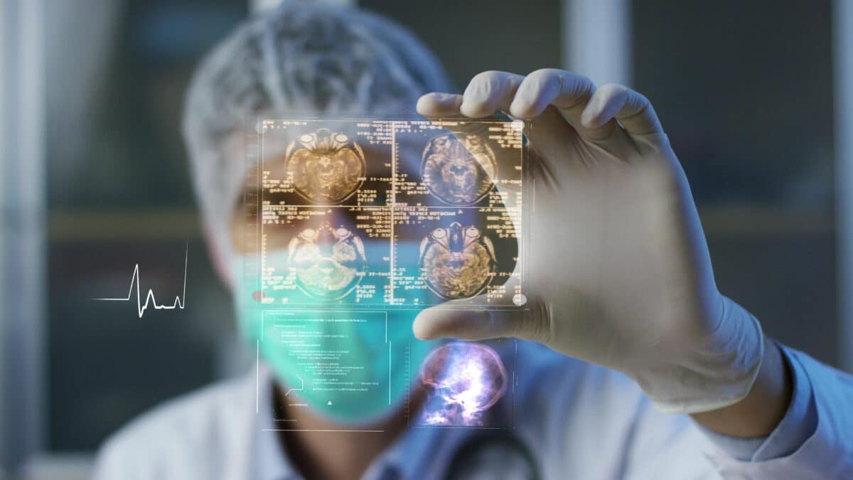 Surgeon analyzes digital hologram displaying patient's healthcare data from medical transcription.