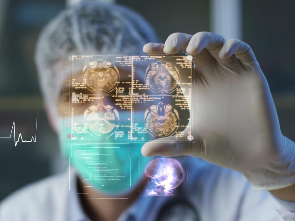 Surgeon analyzes digital hologram displaying patient's healthcare data from medical transcription.