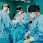 Surgeon performs surgery in surgery center. Transcription helps improve surgeon's work-life balance.