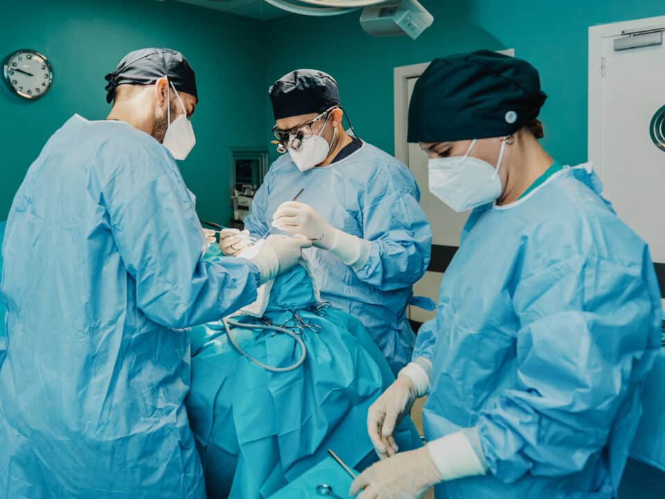 Surgeon performs surgery in surgery center. Transcription helps improve surgeon's work-life balance.