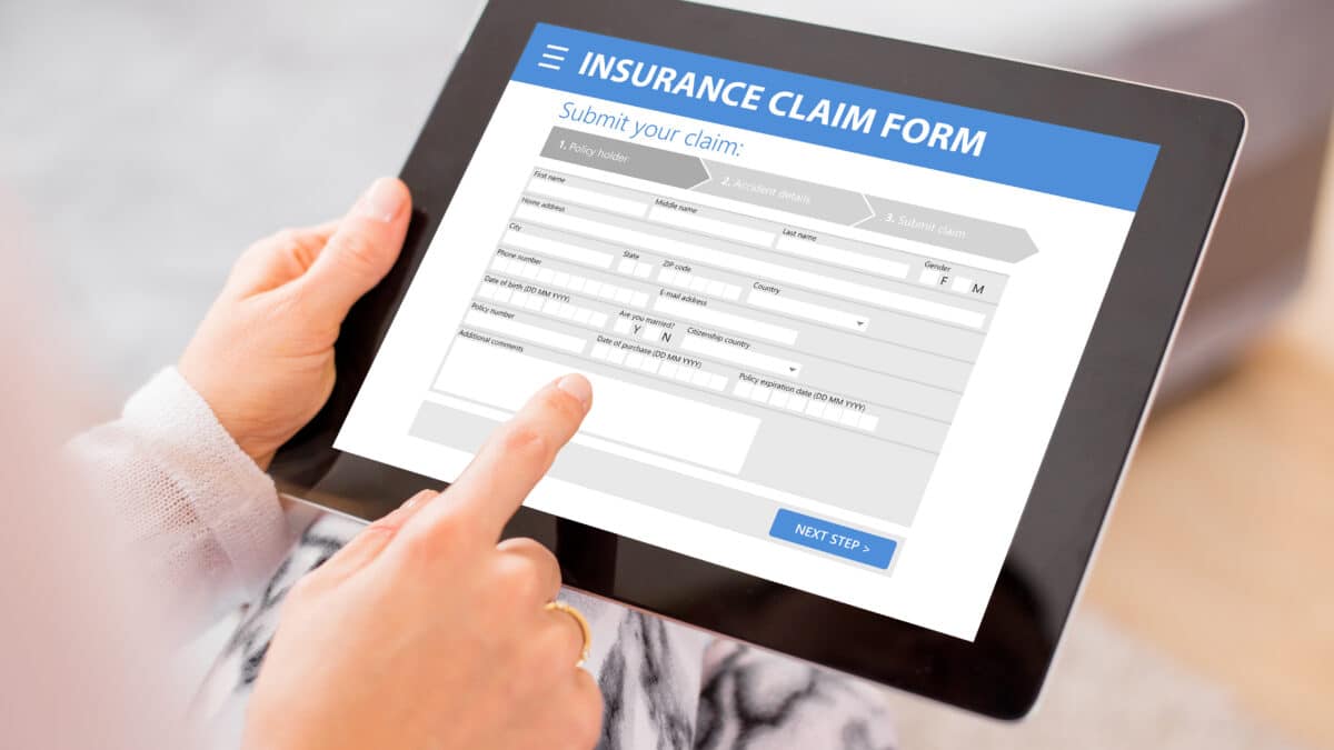 Insurance claim form displays on a tablet; transcription services help streamline claims processing.
