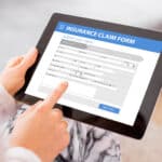 Insurance claim form displays on a tablet; transcription services help streamline claims processing.