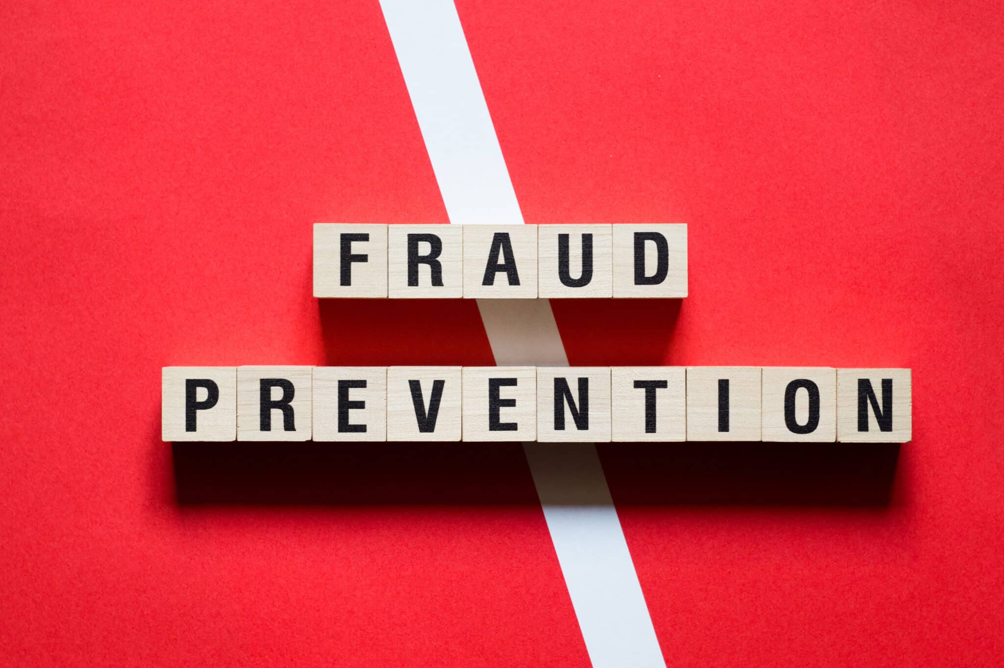 Cubes spell 'Fraud Prevention,' symbolizing the role of insurance transcription to combat fraud.