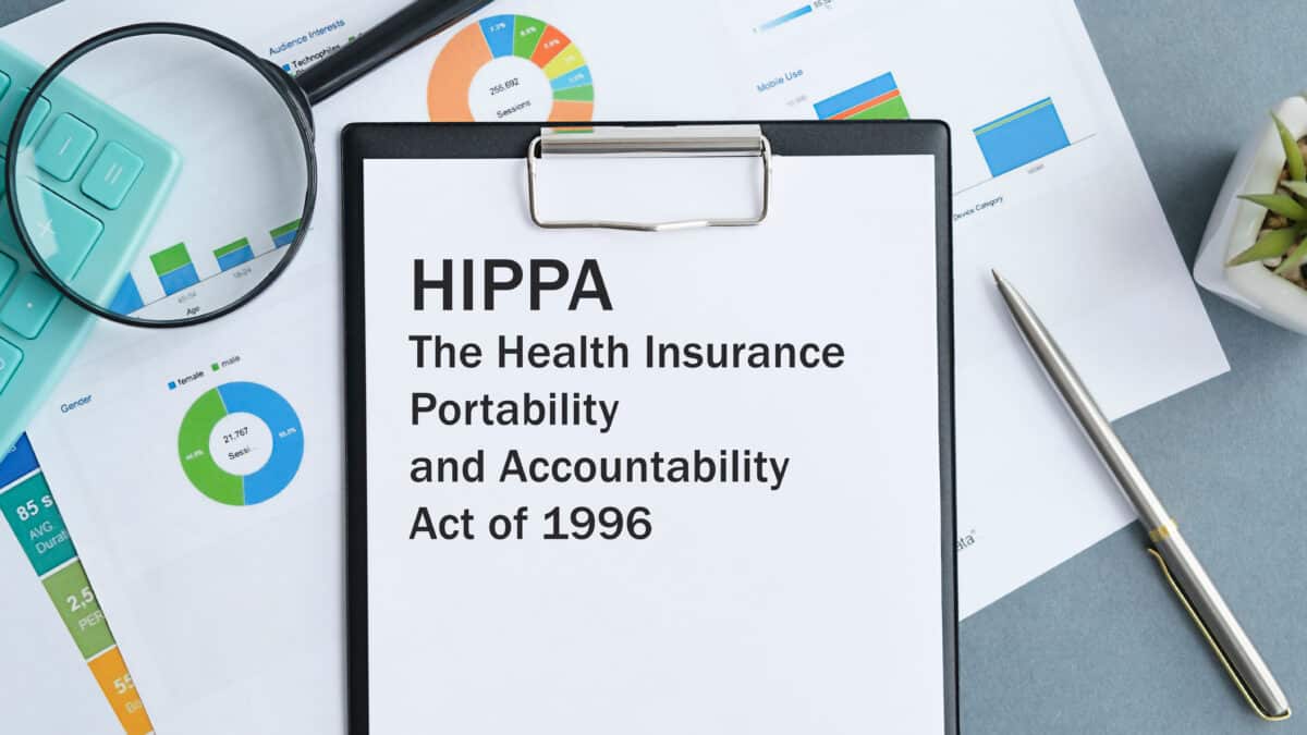 HIPAA Act on clipboard with magnifying glass, symbolizing Athreon's focus on HIPAA compliance.