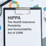 HIPAA Act on clipboard with magnifying glass, symbolizing Athreon's focus on HIPAA compliance.