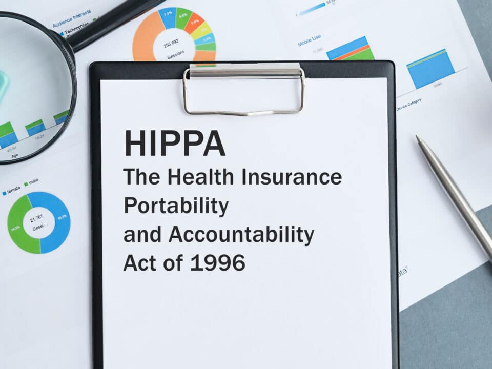 HIPAA Act on clipboard with magnifying glass, symbolizing Athreon's focus on HIPAA compliance.