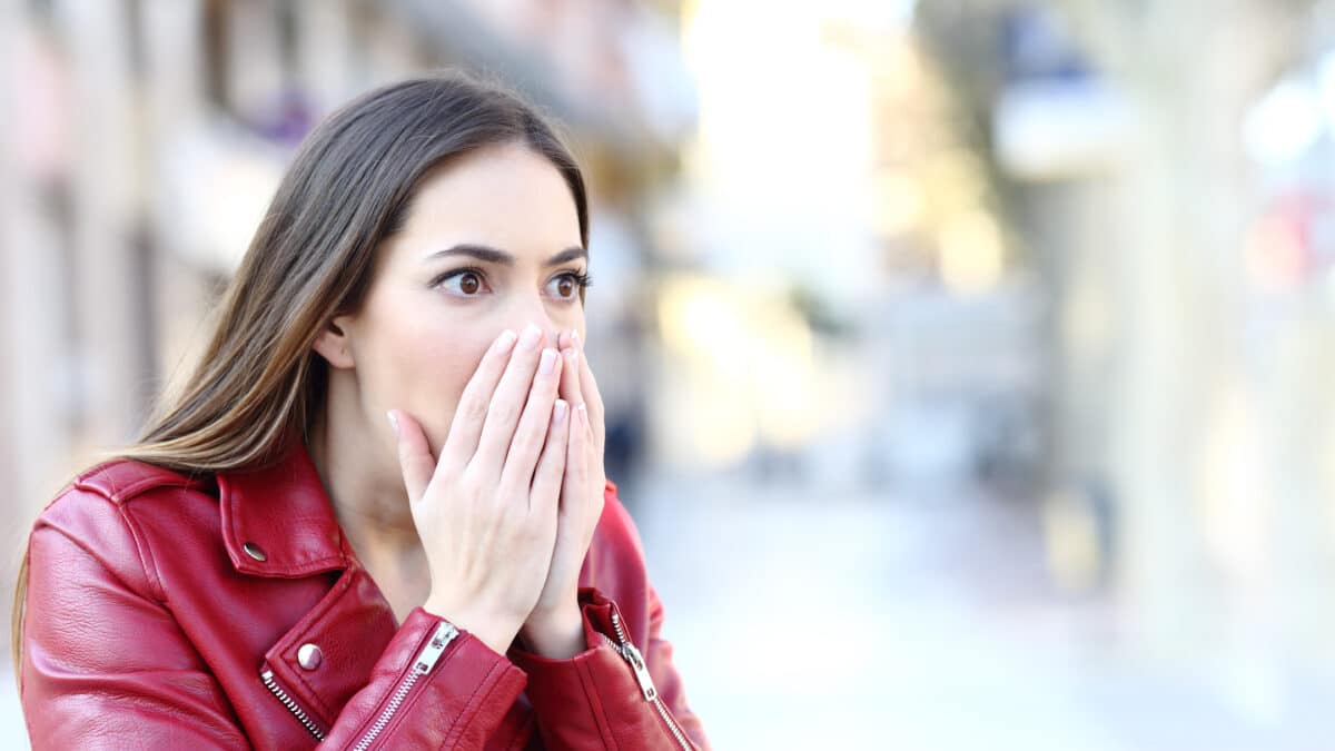 Shocked woman on street, epitomizing key moments crucial in witness statement transcription.