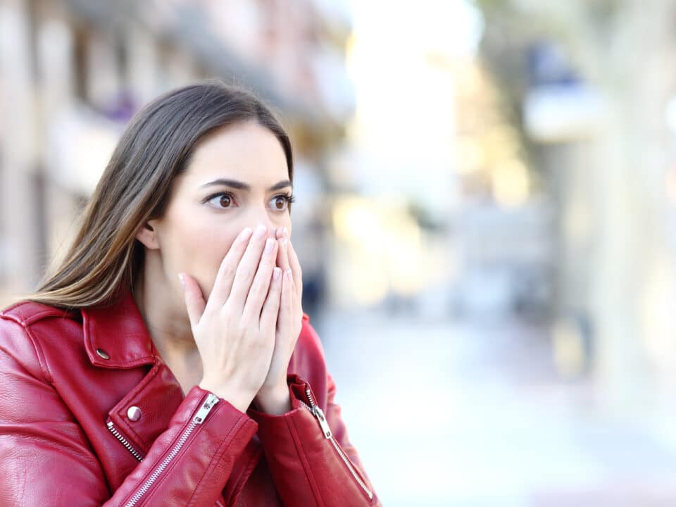 Shocked woman on street, epitomizing key moments crucial in witness statement transcription.