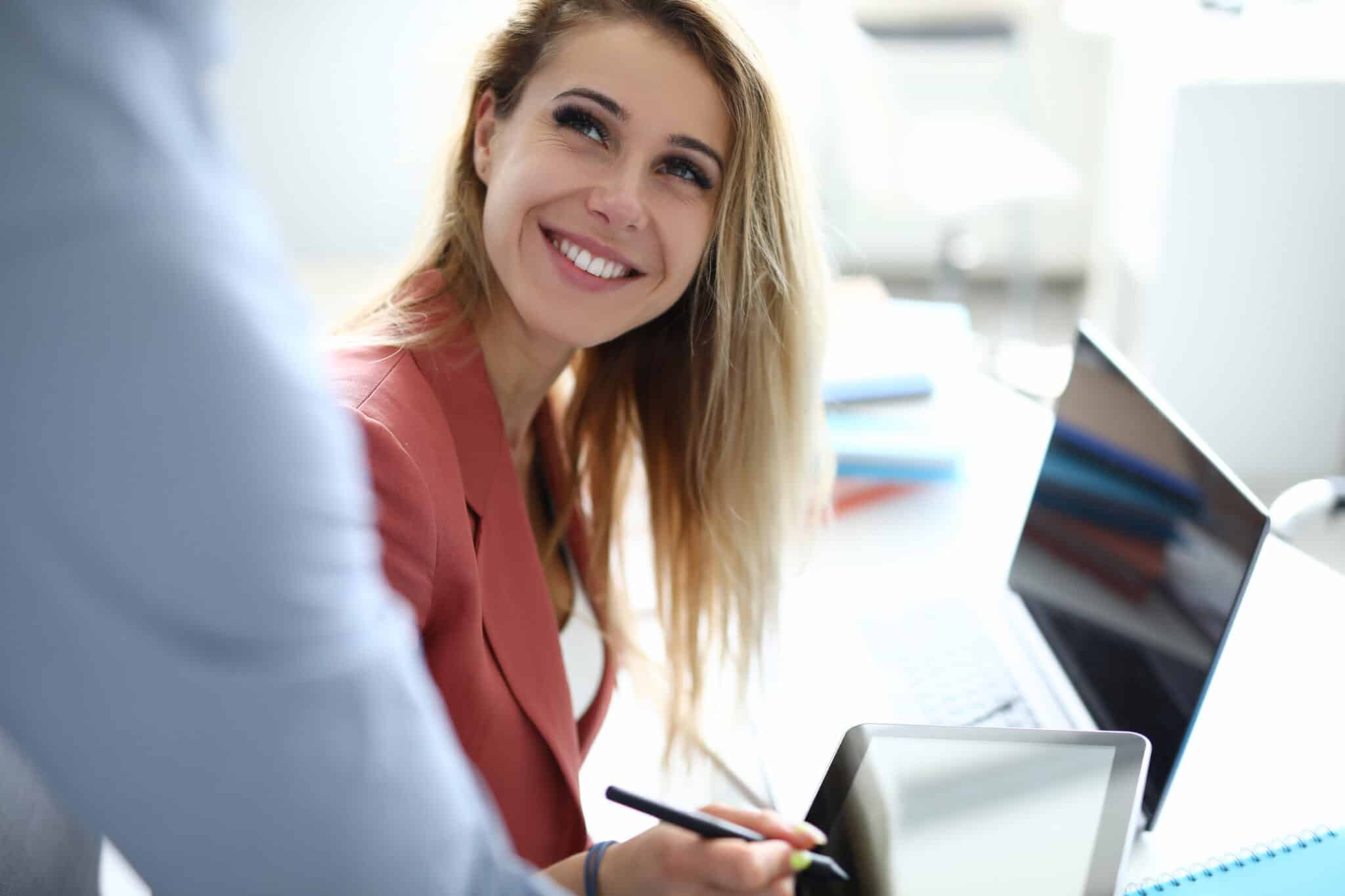 Businesswoman signs an Athreon contract on a tablet, securing tailored transcription services.