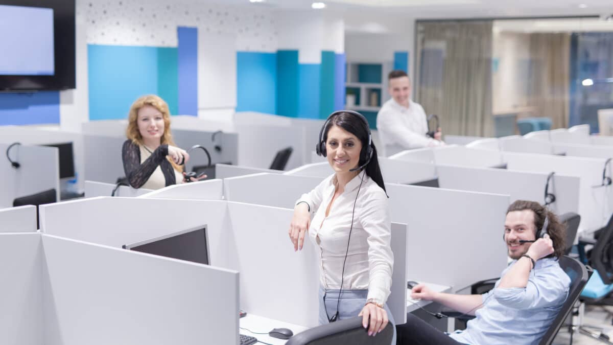 Call center agents with headsets use Athreon's transcription service for accurate conversation logs.