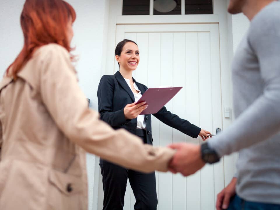 Realtor invites couple to enter a home. She will dictate notes via Athreon's transcription services.