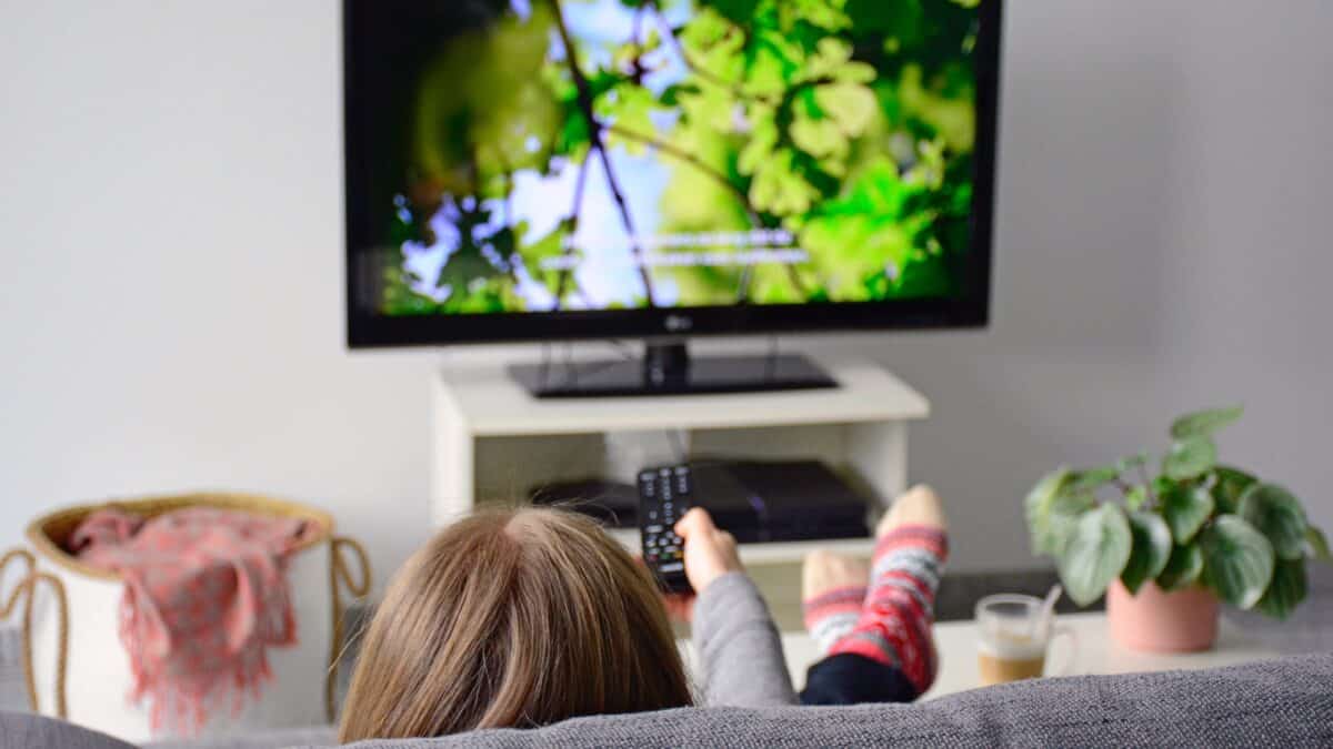 Woman enjoys subtitled nature documentary at home made possible by Athreon's subtitling service.