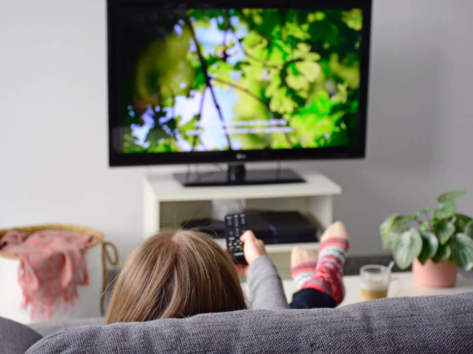 Woman enjoys subtitled nature documentary at home made possible by Athreon's subtitling service.