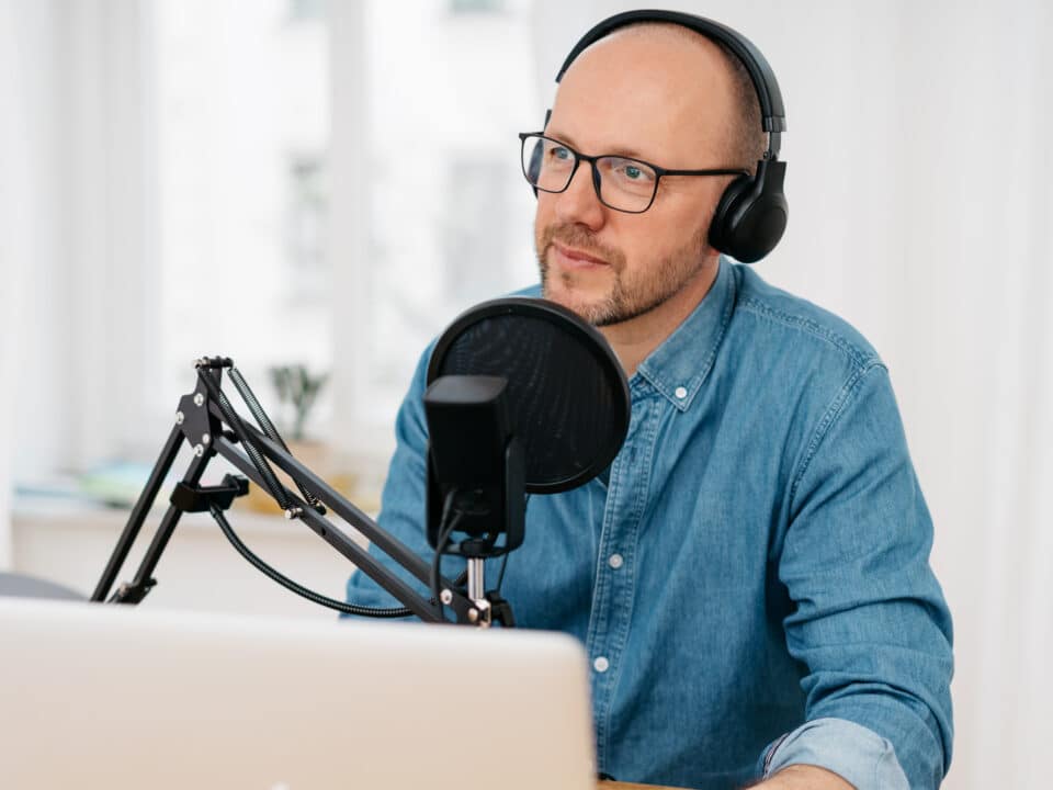 Man considers options among DIY, AI, and professional transcription services for his podcast.