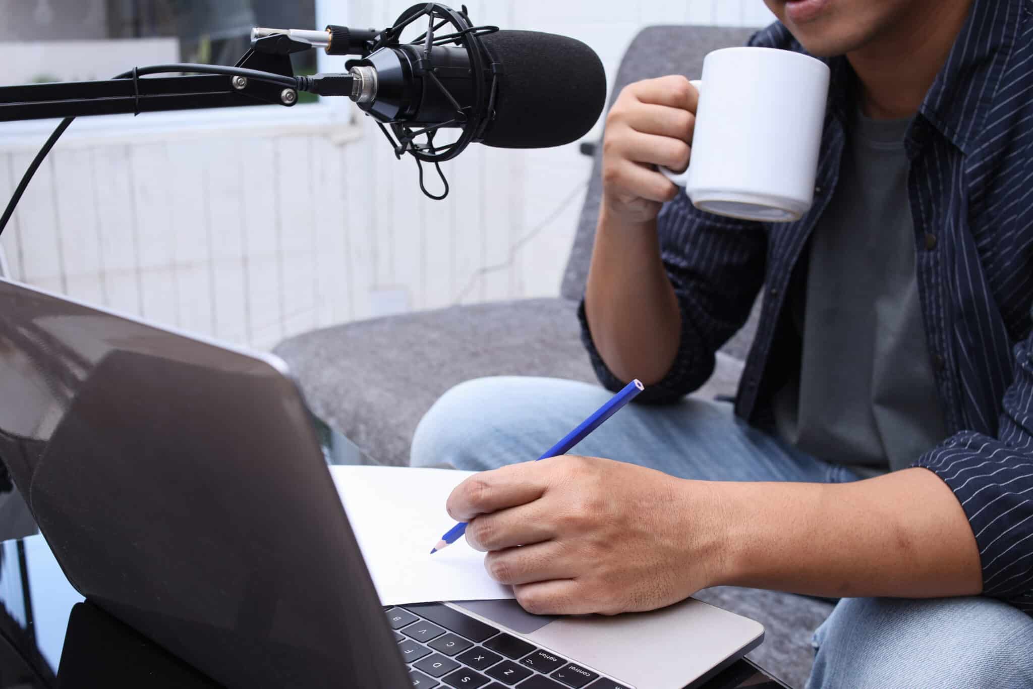 Podcaster prepares content for transcription services, recording with professional gear.