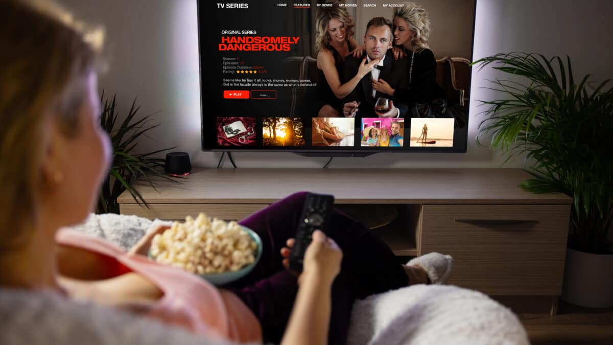 Woman watching a TV series on a streaming service, showcasing the value of Athreon's TV transcripts.