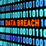 Data breach alert on screen with binary code, emphasizes need for employee cyber security training.