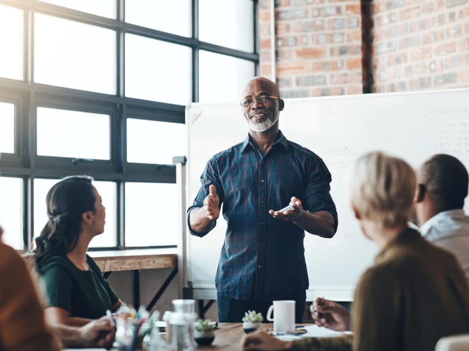 Senior manager leads a cybersecurity training discussion for his small consulting business.