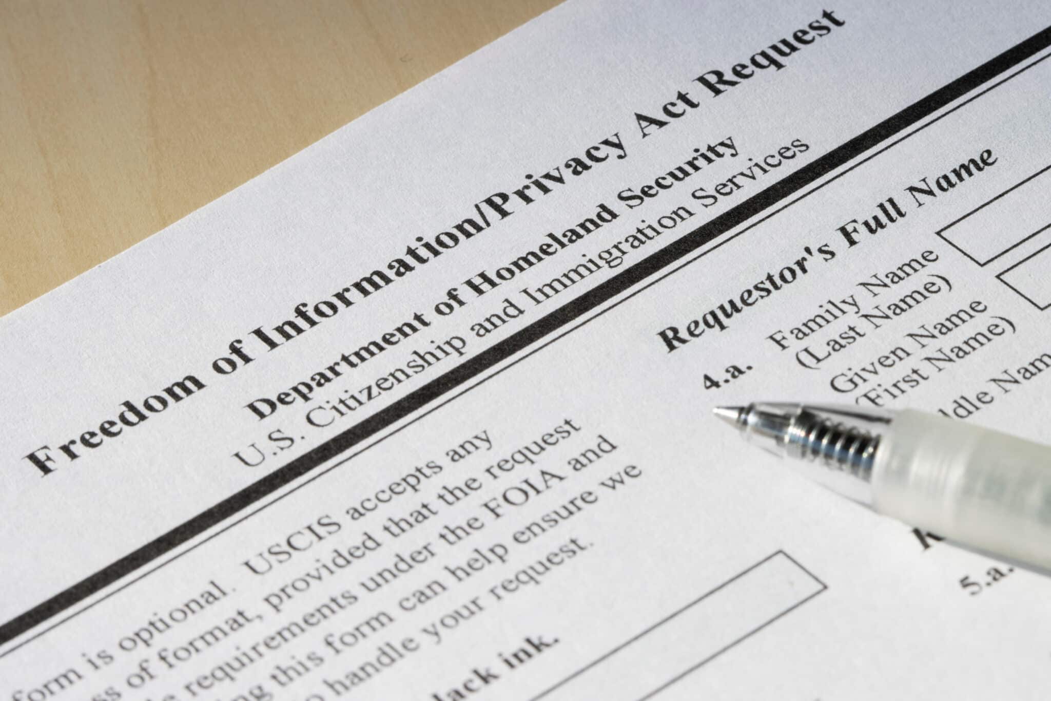 FOIA request form close-up with pen, highlighting the role of transcription in government transparency.